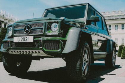 Green luxury SUV parked in an urban area of London, showcasing elegance and automotive design.